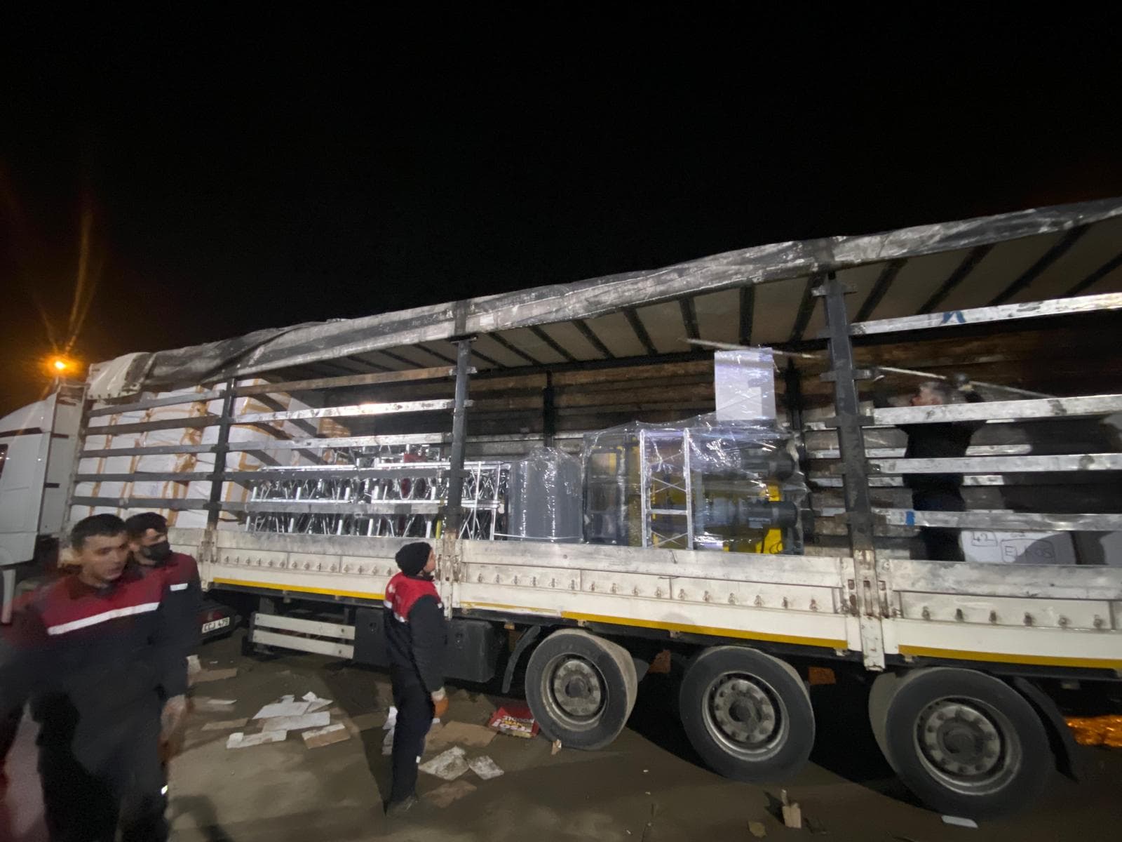 Night-time loading of ALPMAKSAN platform components onto a transport trailer
